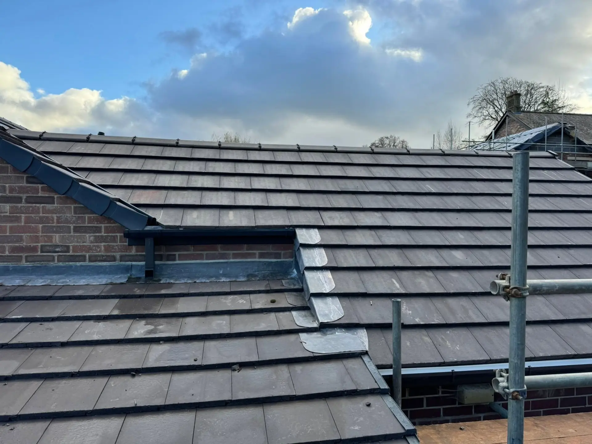 New slate roof with lead flashing detail